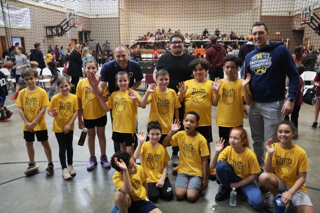 Truth Basketball South Windsor youth team and coaches posing on a gym court.